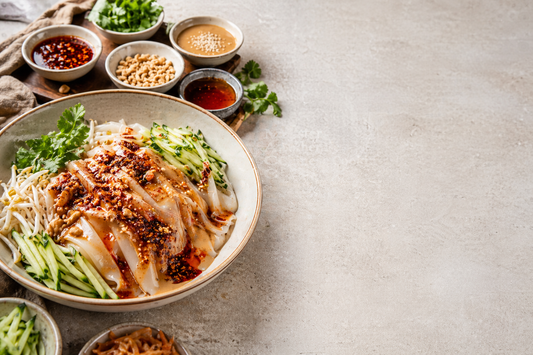 Finished Liangpi and Mipi cold noodles with chili oil, sesame sauce, cucumber, and cold noodle toppings