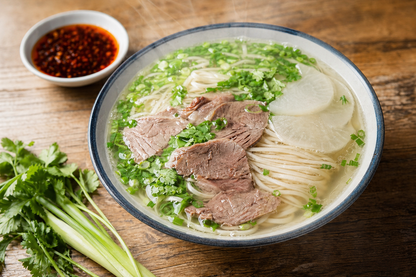 Finished Shaanxi oil-splashed noodles with chili oil, greens, and braised pork